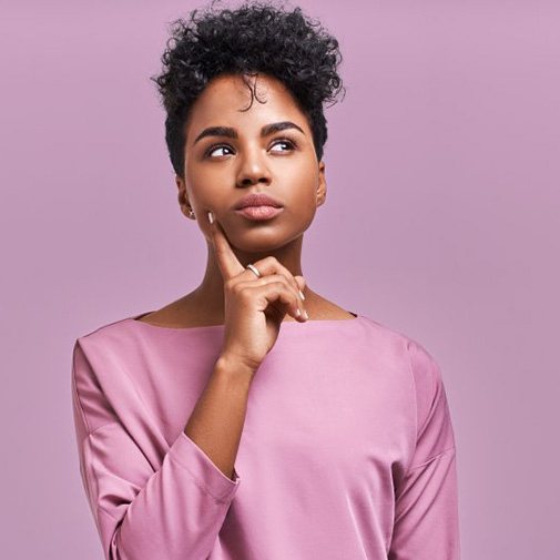 Woman tapping her chin in a questioning pose