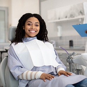 Woman smiling while sitting in treatment chair