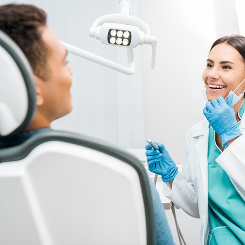 Woman smiling at patient in treatment room