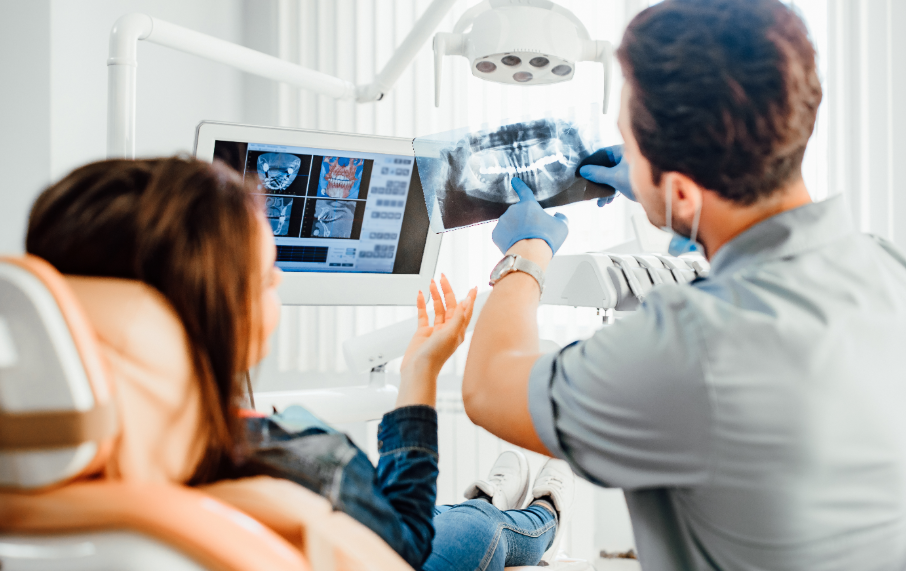 Dentist showing patient x-ray